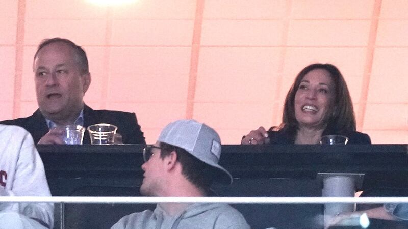 Vice President Kamala Harris and husband Douglas Emhoff watch during the second half of a...