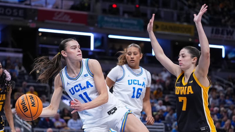 UCLA forward Gabriela Jaquez (11) grabs a rebound in front of Iowa guard Addison Deal (7) in...