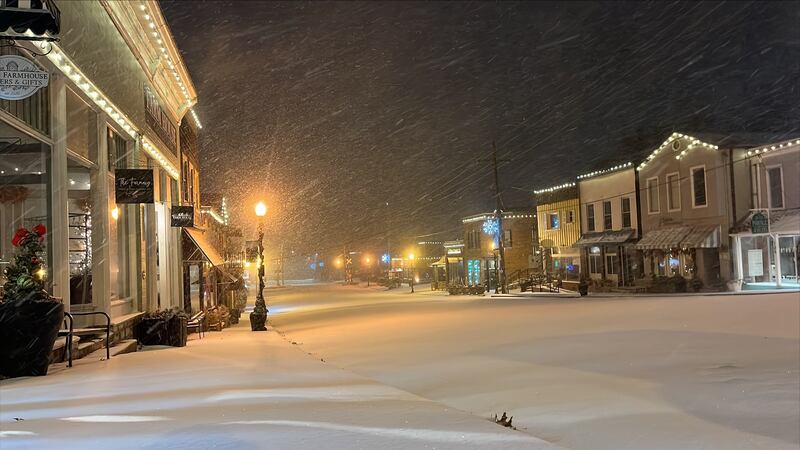 Snow is falling in downtown Parkville, Missouri.