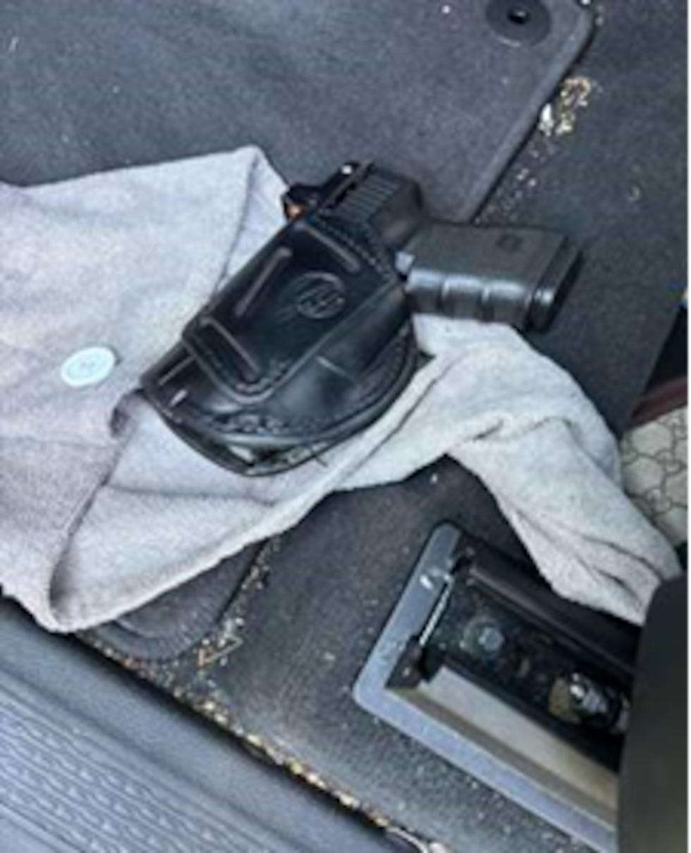 Authorities say they found a gun while removing evidence from a vehicle at the scene.