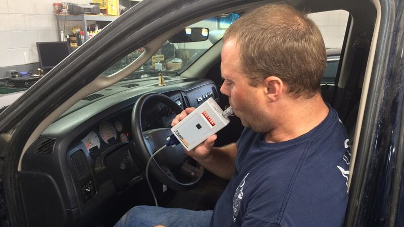 Andy Schriner, owner of A&D Auto Electric, tests one of the ignition interlock devices he...