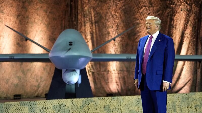 FILE - President Donald Trump stands backdropped by an MQ-9 Reaper drone before addressing...
