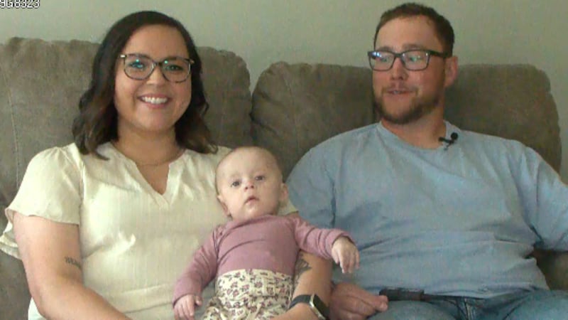 Millie being held by her mom Tayla Schager and dad Dylan Dwyer