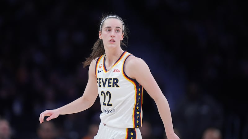 Indiana Fever guard Caitlin Clark (22) watches action during the first half of a WNBA...